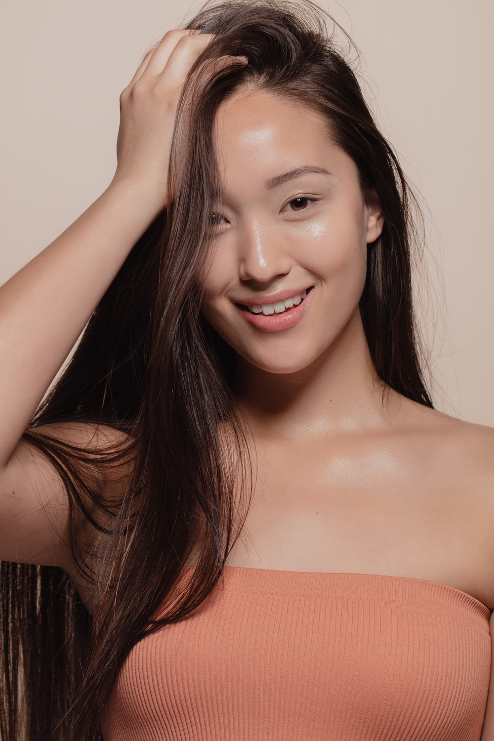 Smiling woman with long, dark hair and natural makeup.