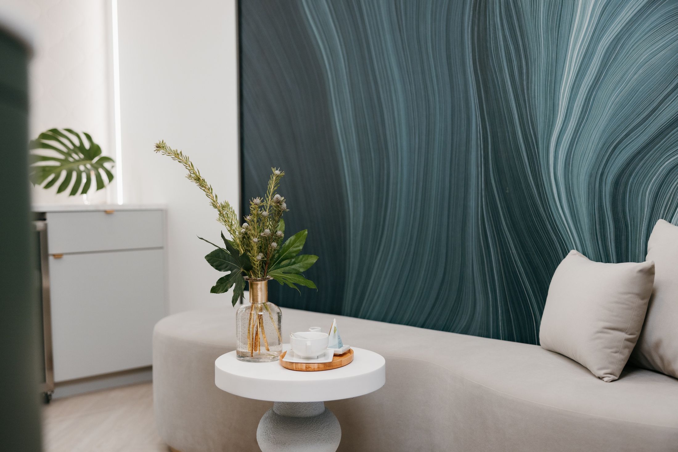 Modern living room with plants and decorative items.