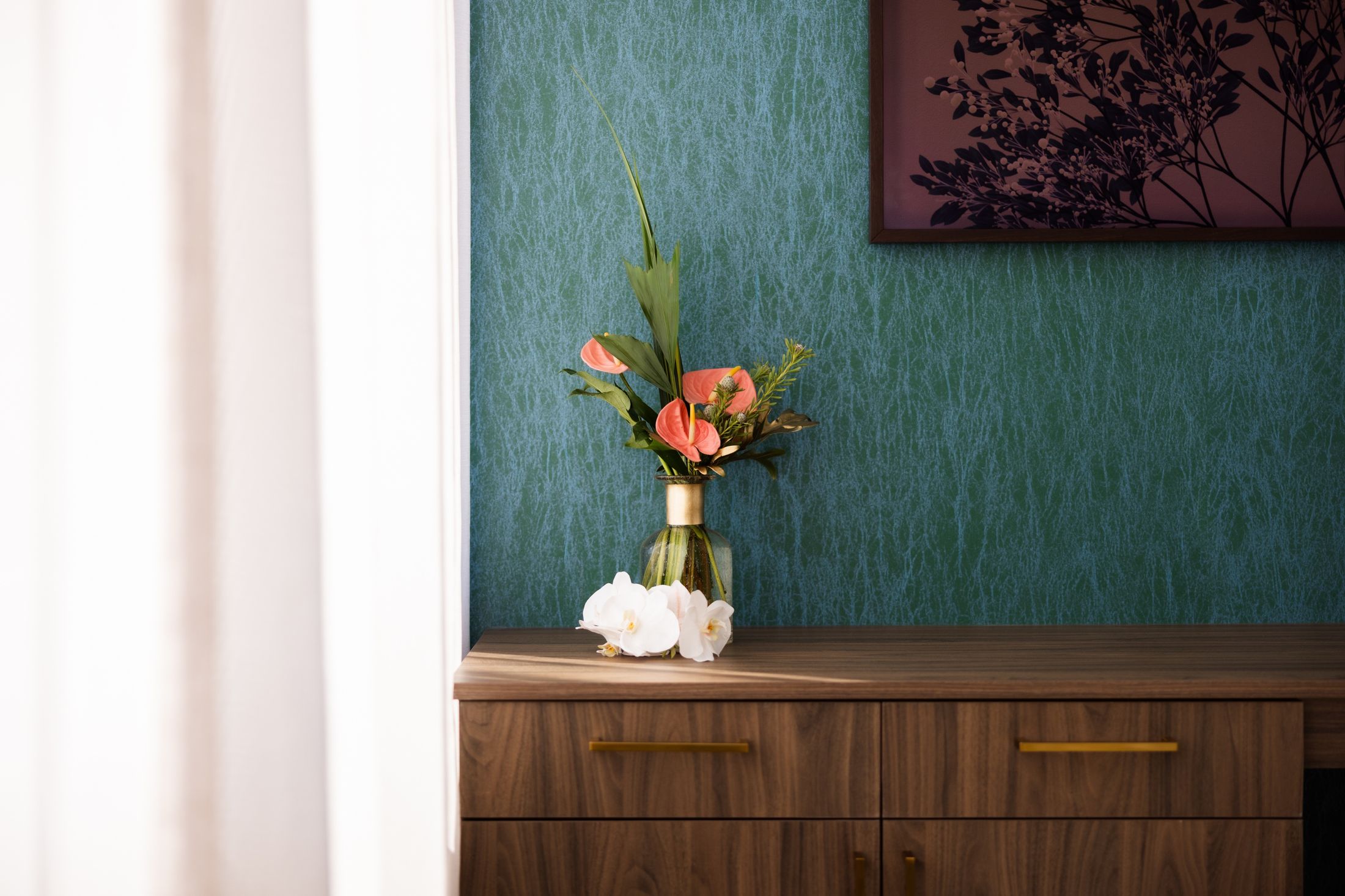 Flowers in a vase on a wooden table.