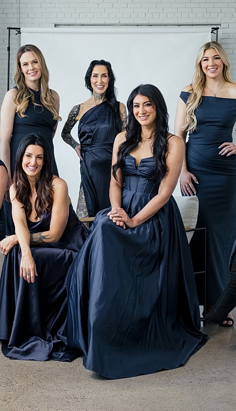 Group of women in elegant navy dresses.