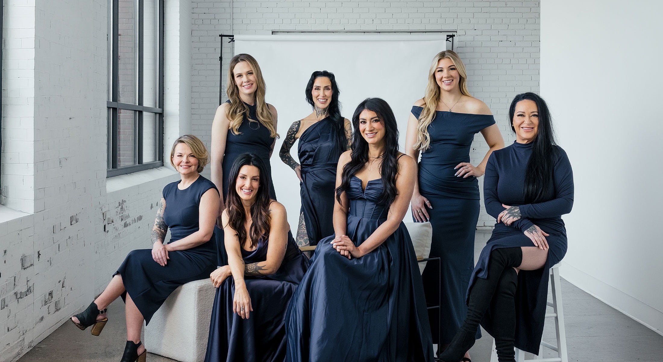 Group of women in elegant navy dresses.